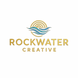 The image contains the Rock Water Creative Logo. It features a circular design resembling a gold sun, ripplles and earth effect. below the arc is a blue embossed wave -like shape. The text ROCKWATER CREATIVE is displayed in capital letters under the the design.